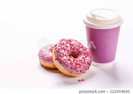 A cheerful display of donuts and a paper coffee cup on a white background A cheerful display of donuts and a paper coffee cup on a white background 122054695