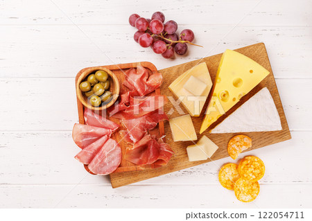 A delectable arrangement of various cheeses, fresh grapes, prosciutto A delectable arrangement of various cheeses, fresh grapes, prosciutto 122054711