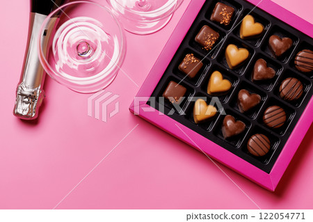 A glasses of champagne elegantly paired with a box of rich chocolates A glasses of champagne elegantly paired with a box of rich chocolates 122054771