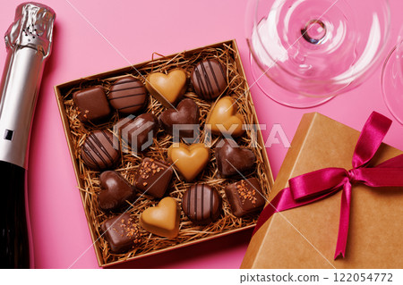 A glasses of champagne elegantly paired with a box of rich chocolates A glasses of champagne elegantly paired with a box of rich chocolates 122054772