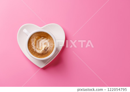A charming coffee cup placed on a heart-shaped saucer A charming coffee cup placed on a heart-shaped saucer 122054795