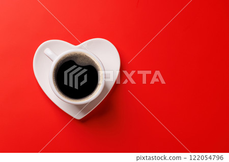 A charming coffee cup placed on a heart-shaped saucer A charming coffee cup placed on a heart-shaped saucer 122054796