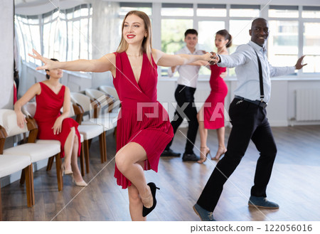 Adult man and young woman dancing twist Adult man and young woman dancing twist 122056016