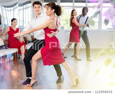 Young guy and adult woman dance tango Young guy and adult woman dance tango 122056018