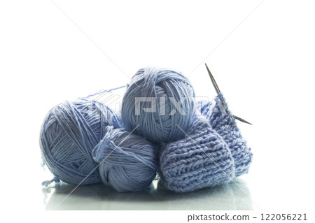 Blue yarn with knitting, isolated on white background 122056221
