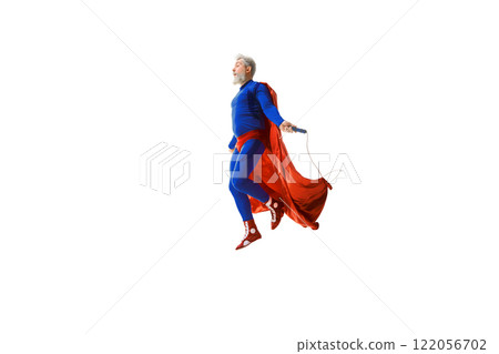 Man in blue superhero costume with red cape training, jumping rope against white studio background 122056702