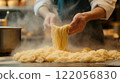 Close up of professional chef serving pasta while working in kitchen. High quality illustration 122056830