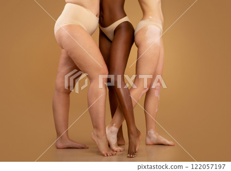 Every Body Is Beautiful. Tree women with different race and body sizes posing in underwear over beige background, cropped image with free space Every Body Is Beautiful. Tree women with different race and body sizes posing in underwear over beige background, cropped image with free space 122057197