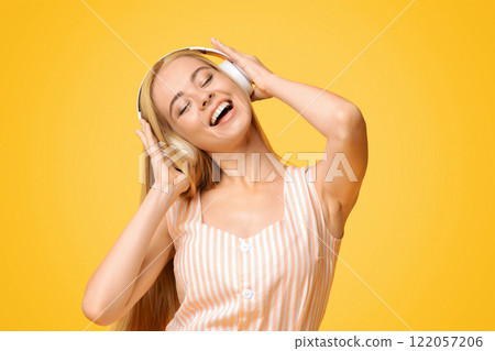 Best Music App. Carefree Teen Girl Listening Her Favorite Song In Wireless Headphones 122057206