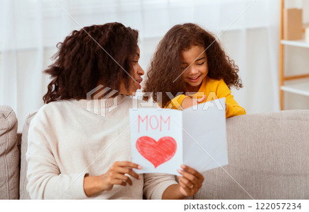 Happy Mother's Day. Little African Girl Congratulating Mom Giving Self-Made Postcard At Home. Happy Mother's Day. Little African Girl Congratulating Mom Giving Self-Made Postcard At Home. 122057234