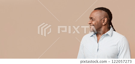 Interesting offer. Positive mature afro american man looking aside at empty space, orange panorama background Interesting offer. Positive mature afro american man looking aside at empty space, orange panorama background 122057273