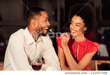 Valentine's Date. Cheerful African American Couple Feeding Each Other Having Romantic Dinner In Fancy Restaurant. Valentine's Date. Cheerful African American Couple Feeding Each Other Having Romantic Dinner In Fancy Restaurant. 122057306