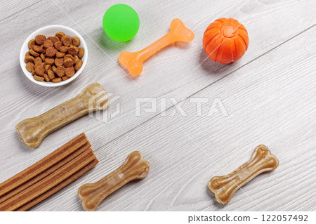 Pet supplies and playful items including dry food and toys for dogs. 122057492