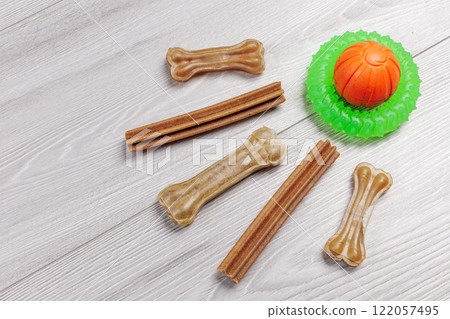 Pet supplies and playful items including dry food and toys for dogs. 122057495