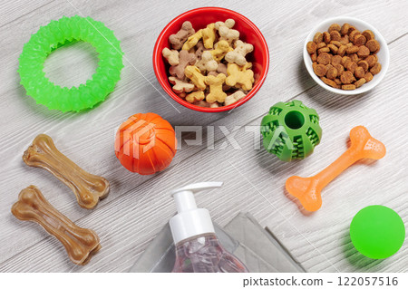 Pet supplies and playful items including a training pad, shampoo, dry food and toys for dogs. Pet supplies and playful items including a training pad, shampoo, dry food and toys for dogs. 122057516