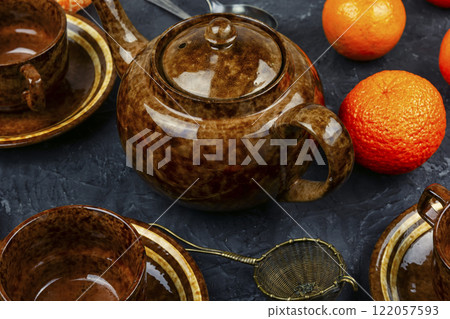 Tangerine tea in a glass teakettle. Tangerine tea in a glass teakettle. 122057593