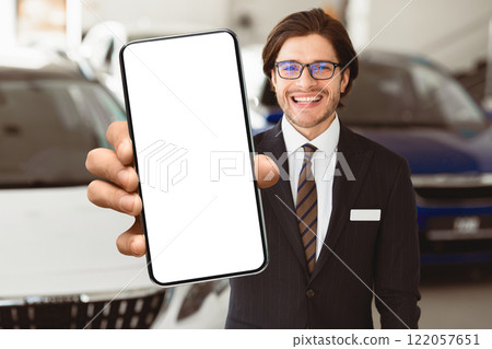 Successful Salesperson. Handsome Agent In Specs Showing Auto Key Standing In Automobile Rental Office, Free Space Successful Salesperson. Handsome Agent In Specs Showing Auto Key Standing In Automobile Rental Office, Free Space 122057651