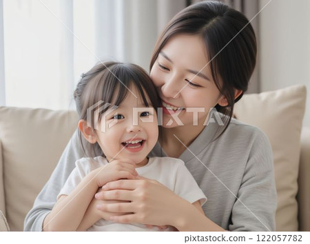Mother and little girl relaxing in living room 122057782