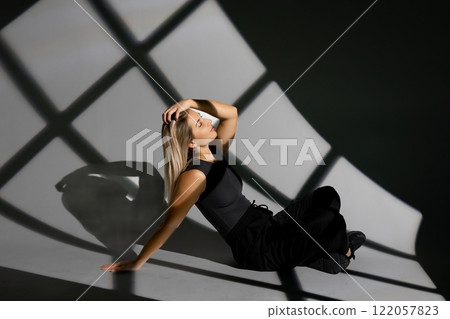Young dancer performing with window-shaped shades on background 122057823