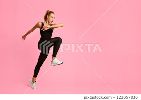 Cardio Workout. Slim Woman Jumping Exercising On Yellow Background In Studio. Sport And Fitness 122057830