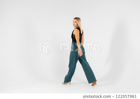 Young blonde dancer posing with hands joined and legs apart on white background Young blonde dancer posing with hands joined and legs apart on white background 122057861