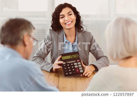 Financial Advice. Professional insurance agent holding calculator, showing amount of insurance case to elderly couple Financial Advice. Professional insurance agent holding calculator, showing amount of insurance case to elderly couple 122057897