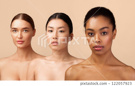 Beauty Portrait. Three Multiracial Women With Perfect Faces And Skin Posing Naked Looking At Camera On Gray Background In Studio. Beauty Portrait. Three Multiracial Women With Perfect Faces And Skin Posing Naked Looking At Camera On Gray Background In Studio. 122057923