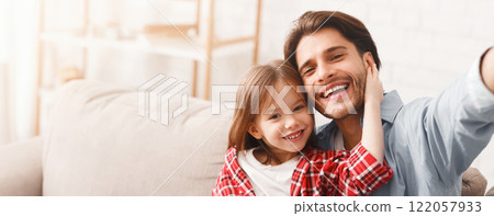 Positive portrait of father and little daughter taking selfie at home, free space Positive portrait of father and little daughter taking selfie at home, free space 122057933