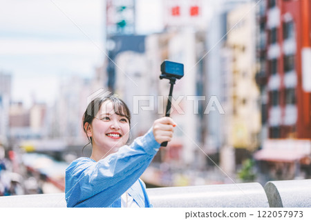 A young woman taking a selfie while sightseeing in Osaka 122057973
