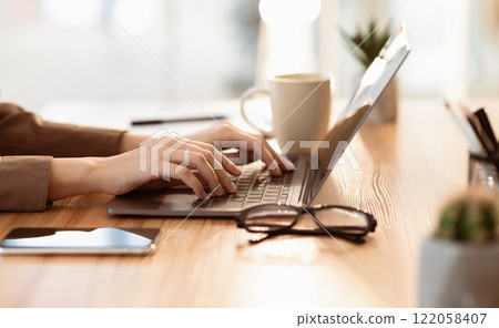 Doing Homework. Close up of teenager typing on laptop, browsing information, preparing project at home, empty space 122058407