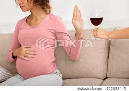 Pregnant woman refusing glass of wine. No alcohol during pregnancy, crop Pregnant woman refusing glass of wine. No alcohol during pregnancy, crop 122058445