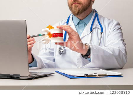 Anatomical lumbar disc herniation model in doctor hand while consultation in medical clinic. Intervertebral hernia treatment Anatomical lumbar disc herniation model in doctor hand while consultation in medical clinic. Intervertebral hernia treatment 122058510