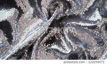 Close-up of sequined fabric in silver, with reflective sequins creating a sparkling effect 122059471