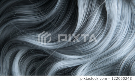 Long, wavy silver hair cascades gently, displaying its glossy texture and movement. The soft strands catch the light beautifully, emphasizing their delicate flow and elegance. Long, wavy silver hair cascades gently, displaying its glossy texture and movement. The soft strands catch the light beautifully, emphasizing their delicate flow and elegance. 122060248