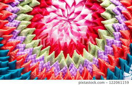 Creative background from handmade multicolored doormat. Texture of rug from different colorful fabrics 122061159