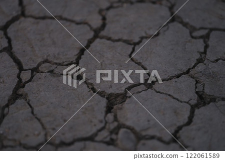 Cracked and Dry Land Surface Texture Represents a Parched Environment and Barren Landscape Cracked and Dry Land Surface Texture Represents a Parched Environment and Barren Landscape 122061589