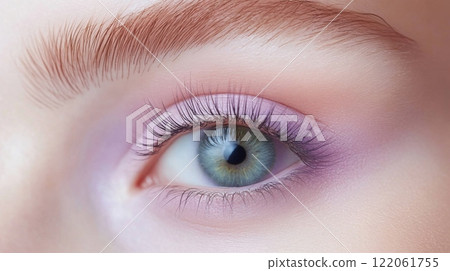 A woman showcases her eye makeup with gentle pastels, highlighting her green eye and long lashes. The soft colors create an elegant look fitting for a beauty event in the late afternoon. A woman showcases her eye makeup with gentle pastels, highlighting her green eye and long lashes. The soft colors create an elegant look fitting for a beauty event in the late afternoon. 122061755