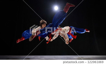 Group in synchronized Hopak leap, extended kicks and flowing costumes celebrating harmony, vitality, and cultural storytelling. 122061869