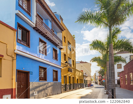 Tenerife. Colourful houses and palm trees on street in Puerto de la Cruz town, Tenerife, Canary Islands, Spain. Tenerife. Colourful houses and palm trees on street in Puerto de la Cruz town, Tenerife, Canary Islands, Spain. 122062840
