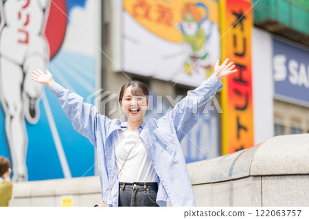 Young woman sightseeing in Osaka, Japan Young woman sightseeing in Osaka, Japan 122063757