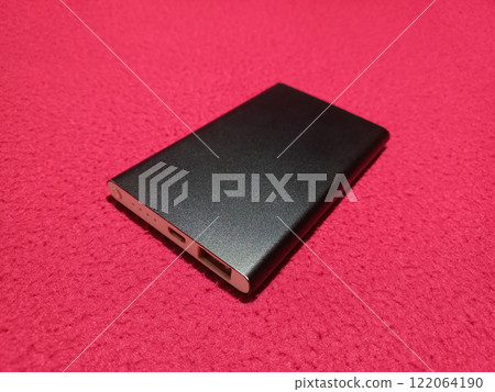 Power bank for charging mobile devices. Black and white smart phone power bank. External battery for mobile devices. Power bank for charging mobile devices. Black and white smart phone power bank. External battery for mobile devices. 122064190