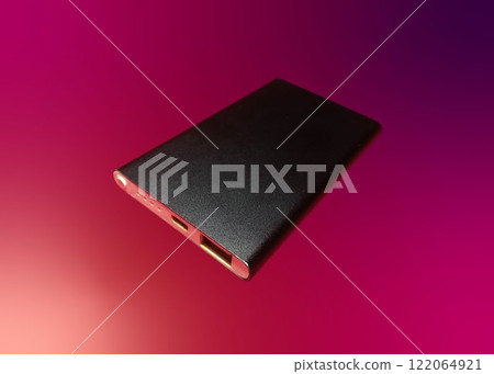 External battery for mobile devices. Power bank for charging mobile devices, isolated on colored background 122064921