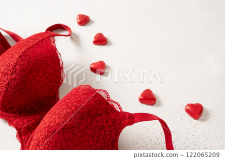 Lace sexy red womens underwear and candy sweets on white background. Love. Close up. Romantic dating. Lace sexy red womens underwear and candy sweets on white background. Love. Close up. Romantic dating. 122065209