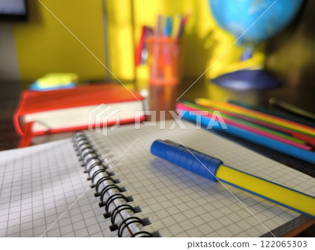 office objects on the desktop, against the background of the globe 122065303