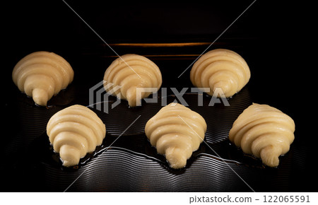 Homemade croissants baking in oven , close-up 122065591
