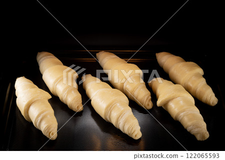 Homemade croissants baking in oven , close-up 122065593