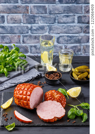 boneless smoked ham on black slate board, top view boneless smoked ham on black slate board, top view 122066409