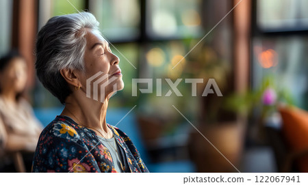 Older woman enjoys peaceful moment in a bright cafe during late afternoon Older woman enjoys peaceful moment in a bright cafe during late afternoon 122067941