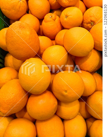 Freshly harvested oranges piled high in a vibrant display at the local market 122068130