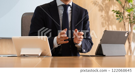 Businessmen discussing business in a conference room Businessmen discussing business in a conference room 122068645